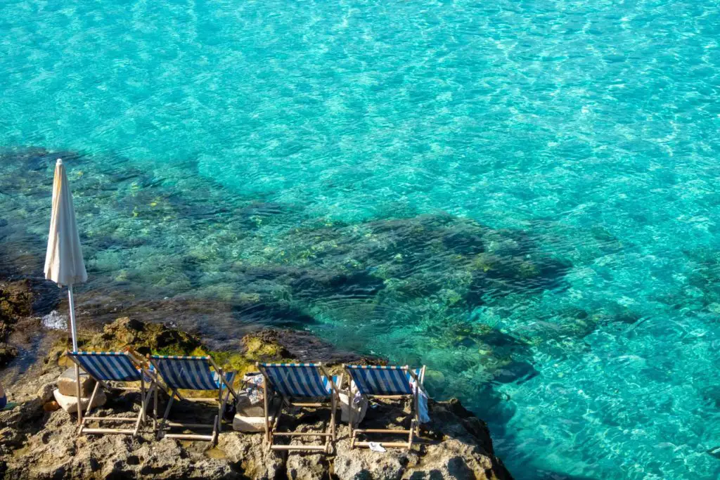 blue lagoon in Malta, turquoise waters, beach chairs