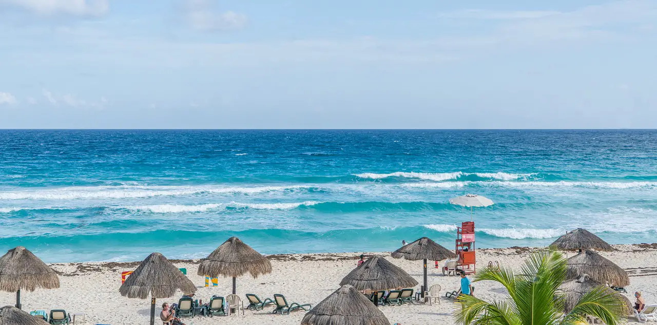 Itinerary for Cancun, beach in Cancun, rolling waves, beach huts, Cancun, Mexico