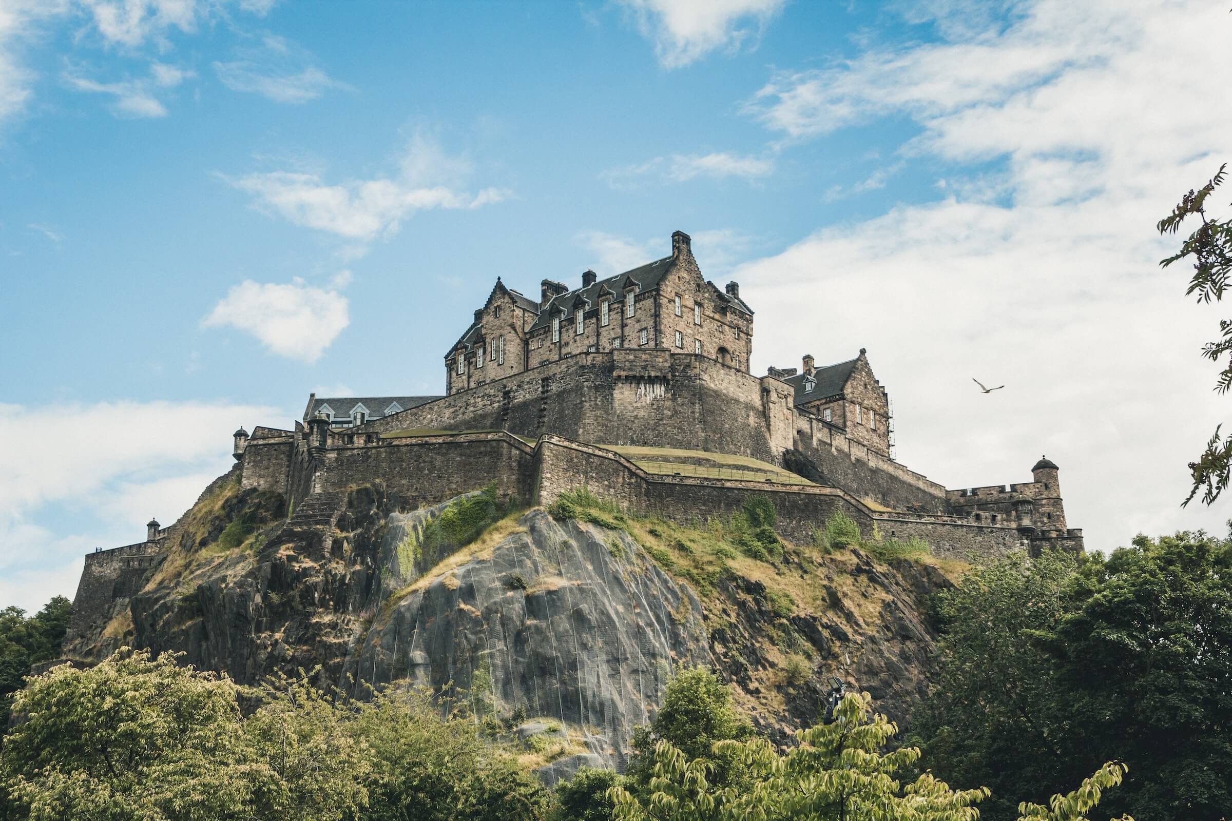 24 hours in Edinburgh. This is an image of Edinburgh from the ground. The castle sits on a hill and has a panoramic view of Edinburgh's cityscape.
